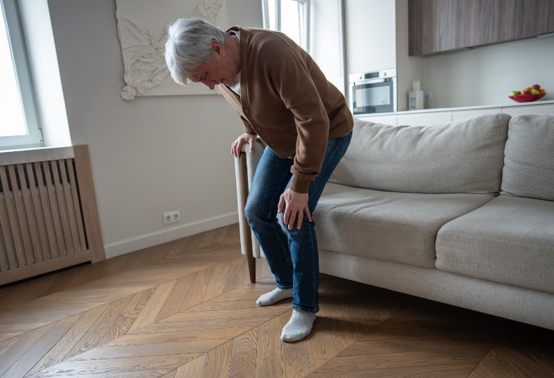 Early signs of muscle loss in older adult struggling to stand from a chair.