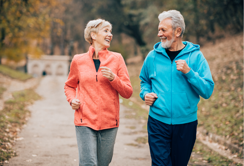 Older man performing strength training with weights at the gym to help prevent muscle loss after 50.