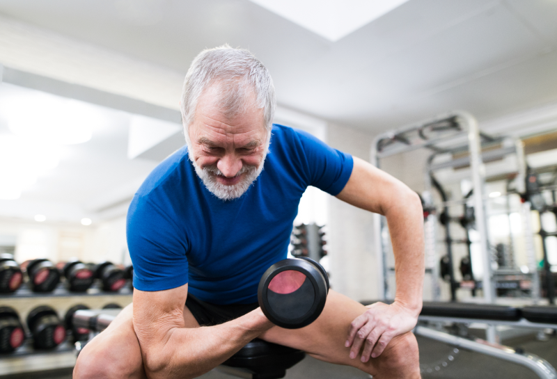 elderly man lifting weights