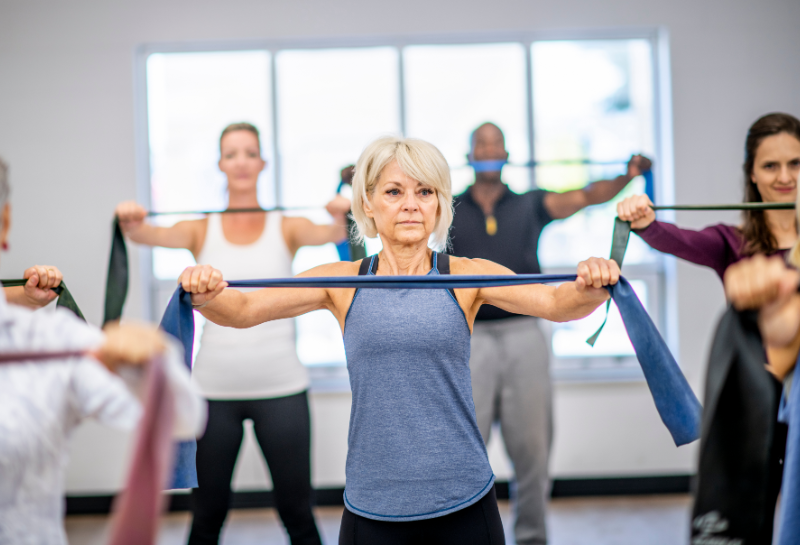 healthy seniors using resistance bands to build muscle