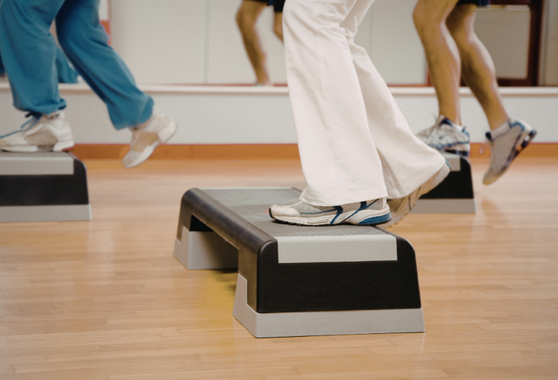 Older adults performing step-up exercises on a fitness platform to improve leg strength and balance after 60.