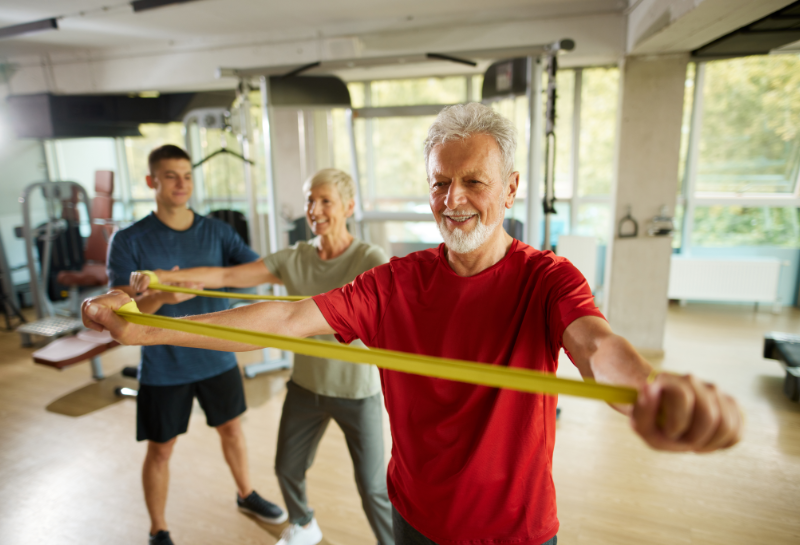 Older adults doing resistance band exercises to help prevent muscle loss after 50.